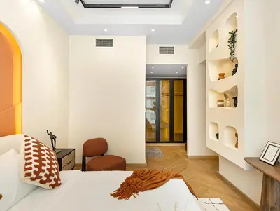 a bedroom with a bed and a desk and a chair at Luxury 2BR Apartment in Dubai Marina with Full Marina View in Dubai