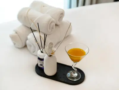a table with a drink and a towel and a glass at Luxury 2BR Apartment in Dubai Marina with Full Marina View in Dubai