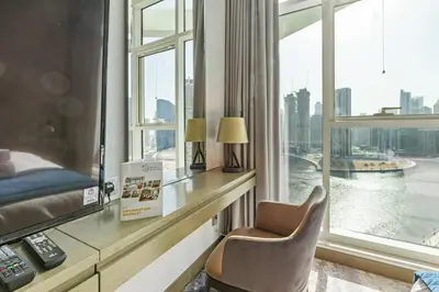 a room with a desk with a chair and a window at BLVD - Stunning Canal View - 5 Minutes from Burj Khalifa in Dubai