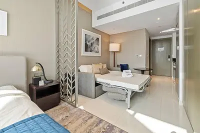 a hospital room with a bed and a couch at BLVD - Stunning Canal View - 5 Minutes from Burj Khalifa in Dubai