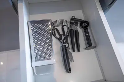 a bunch of kitchen utensils are hanging in a drawer at BLVD - Stunning Canal View - 5 Minutes from Burj Khalifa in Dubai