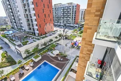 an aerial view of the courtyard of a building with a swimming pool at Modern Cozy 1BR Retreat Azizi Riviera Dubai in Dubai
