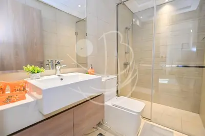 a bathroom with a sink and a toilet and a shower at Modern Cozy 1BR Retreat Azizi Riviera Dubai in Dubai