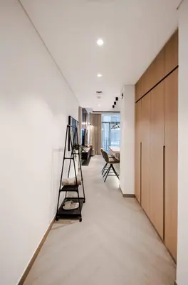 a hallway with a ladder and a desk in a room at Luxury Upgraded Studio in Wilton Park Residences in Dubai