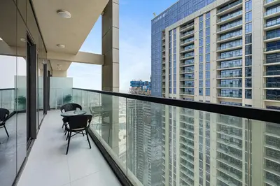 a balcony with chairs and a view of a building at Luxury Penthouse - Scenic View - Near Burj Khalifa in Dubai