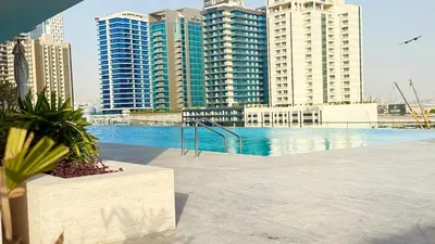a swimming pool in a city with tall buildings at Private jacuzzi Canal View Infinity Pool in Dubai