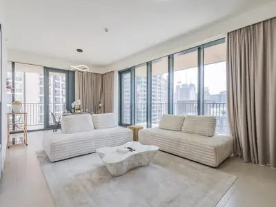 a living room with two white couches and large windows at TRPS - BLVD Heights, Downtown Dubai - Luxury 1BR, Close to Dubai Mall in Dubai