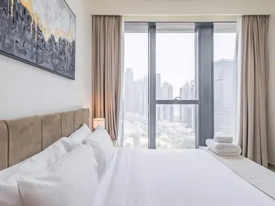 a bedroom with a large bed with a large window at TRPS - BLVD Heights, Downtown Dubai - Luxury 1BR, Close to Dubai Mall in Dubai