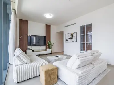 a living room with two white couches and a tv at TRPS - BLVD Heights, Downtown Dubai - Luxury 1BR, Close to Dubai Mall in Dubai