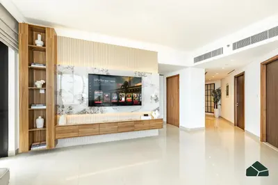 a living room with a television on a wall at High Floor 2BR with Full Burj View by BMS in Dubai