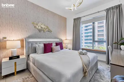 a bedroom with a large bed and a window at bnbmehomes - 29 Boulevard Tower 1 in Dubai
