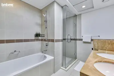 a bathroom with a tub and a sink and a shower at bnbmehomes - 29 Boulevard Tower 1 in Dubai