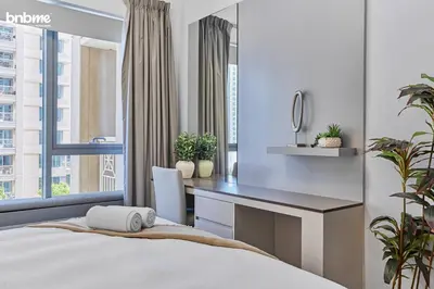 a bedroom with a desk and a bed at bnbmehomes - 29 Boulevard Tower 1 in Dubai