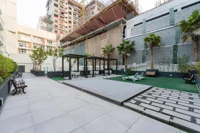 a courtyard in a building with a pavilion at Lux & New 2 BHK in Jumeirah Village Circle I Close to everything I Pool I High Speed Internet I Balcony in Dubai