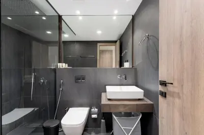 a bathroom with a sink and a toilet and a mirror at Lux & New 2 BHK in Jumeirah Village Circle I Close to everything I Pool I High Speed Internet I Balcony in Dubai