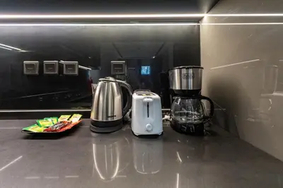 a kitchen counter with a blender and a toaster at Lux & New 2 BHK in Jumeirah Village Circle I Close to everything I Pool I High Speed Internet I Balcony in Dubai