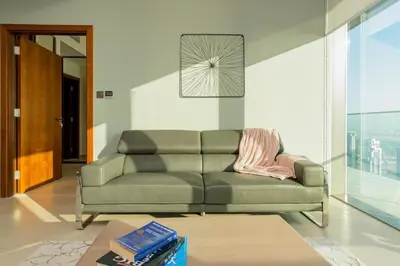 a living room with a couch and a table at Vacay Lettings - Marina Gate 2 in Sabkhah