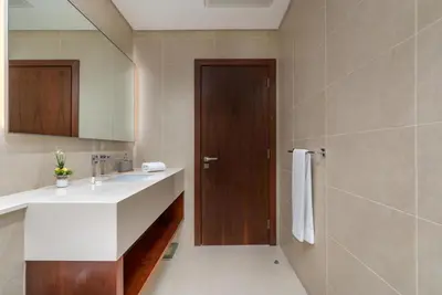 a bathroom with a sink and a mirror at Vacay Lettings - Marina Gate 2 in Sabkhah