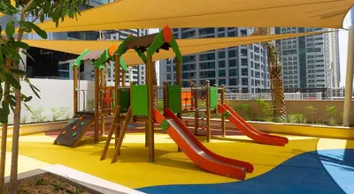 a playground with a slide and a slide at Vacay Lettings - Marina Gate 2 in Sabkhah