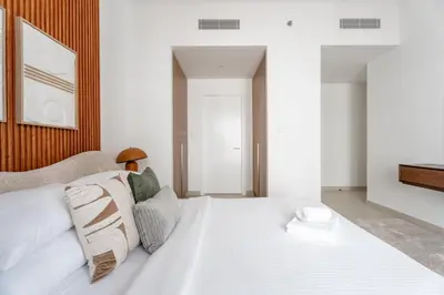 a bedroom with a large white bed with pillows at GuestReady - Tasteful home in Dubai Creek Harbour in Dubai