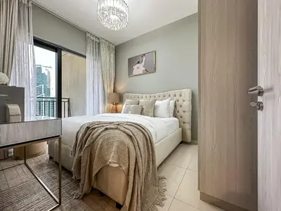 a bedroom with a large bed and a window at Chic 1BR in Business Bay City Views & Upscale Comfort in Dubai