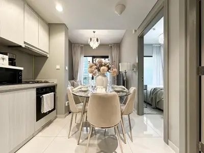 a kitchen and dining room with a table and chairs at Chic 1BR in Business Bay City Views & Upscale Comfort in Dubai