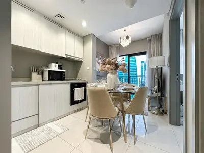 a kitchen and dining room with a table and chairs at Chic 1BR in Business Bay City Views & Upscale Comfort in Dubai