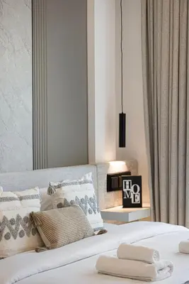 a bedroom with a large white bed with pillows at Elegant 4BR Villa, Luxury Pool Retreat, Joy, Arabiana Ranches 3 in Sabkhah