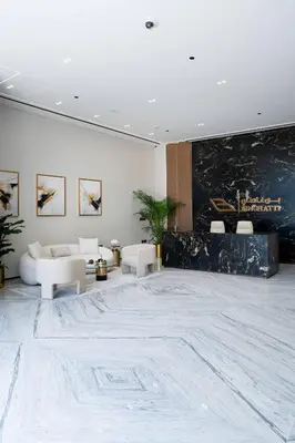 a lobby with white furniture and a large marble floor at Soft Modernity 1br Haven With Parking, Gym & Pool! in Dubai