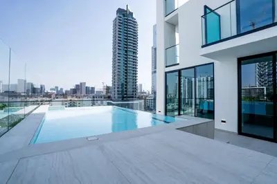 a swimming pool on the roof of a building at Soft Modernity 1br Haven With Parking, Gym & Pool! in Dubai