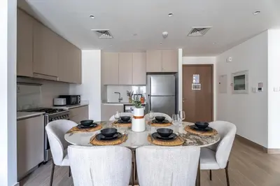 a kitchen and dining room with a table and chairs at GuestReady - Stylish Stay with Dubai Skyline Views in Dubai