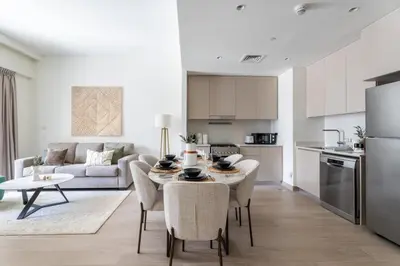 a kitchen and living room with a table and chairs at GuestReady - Stylish Stay with Dubai Skyline Views in Dubai