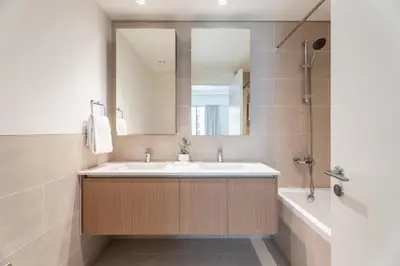a bathroom with a sink and a mirror and a tub at GuestReady - Stylish Stay with Dubai Skyline Views in Dubai