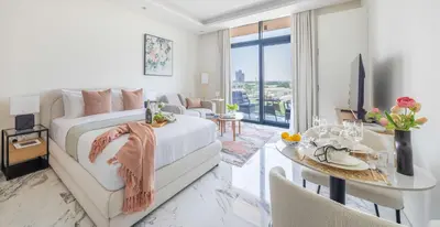 a living room with a bed and a dining room at Frank Porter - Taraf 2 Residence in Dubai