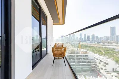 a chair on a balcony with a view of the city at Bloomfields Cozy 1BR Binghatti Nova in Dubai