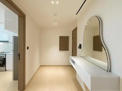 a hallway of a house with a mirror on the wall at Big 1BR Apartment in JVC Binghatti Corners in Dubai