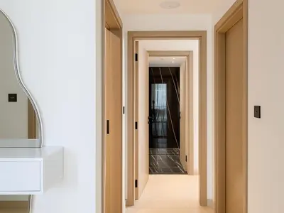 a hallway in a house with an open door at Big 1BR Apartment in JVC Binghatti Corners in Dubai