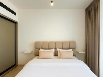 a bedroom with a large white bed with two pillows at Big 1BR Apartment in JVC Binghatti Corners in Dubai