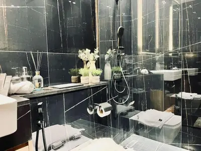 a bathroom with two sinks and a shower at Sun Deck & Sleek Lap Pool Free Gym And Parking! in Dubai