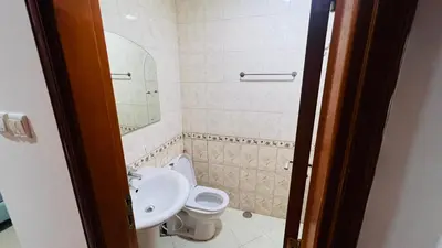 a bathroom with a toilet and a sink at Duo Den Partiton Room In tecom Barsha Heights in Dubai