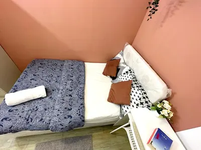 a small bed with blue and white sheets and pillows at Duo Den Partiton Room In tecom Barsha Heights in Dubai