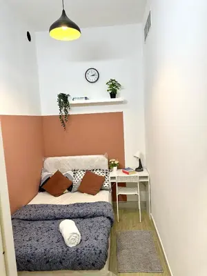a small bedroom with a bed and a desk at Duo Den Partiton Room In tecom Barsha Heights in Dubai