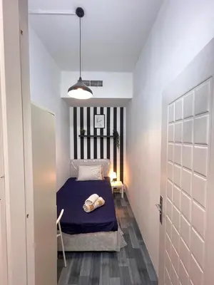 a small bedroom with a bed in a room at Eden Retreat Partition room For Couple In Barsha Heights in Dubai
