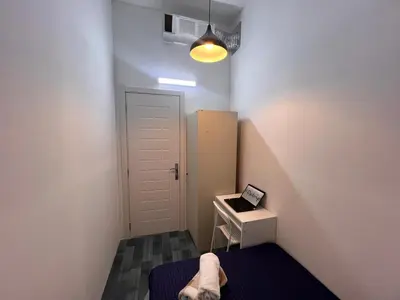 a small room with a bed and a white door at Eden Retreat Partition room For Couple In Barsha Heights in Dubai