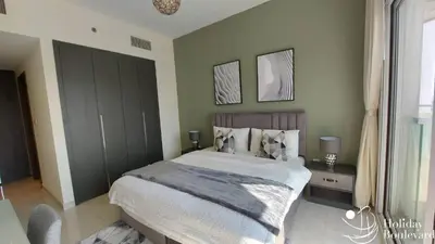 a bedroom with a large bed and a window at Stylish 1br Brand New Prime Business Bay Stay in Dubai