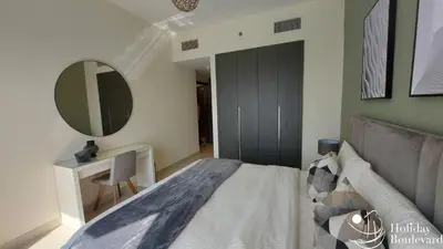 a bedroom with a bed and a mirror on the wall at Stylish 1br Brand New Prime Business Bay Stay in Dubai