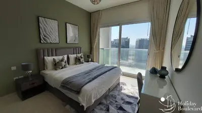 a bedroom with a bed and a large window at Stylish 1br Brand New Prime Business Bay Stay in Dubai