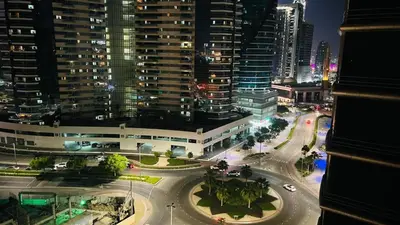 a view of a city at night with buildings at Enchanted Stay Partition Room in Barsha Heights in Tecom in Dubai