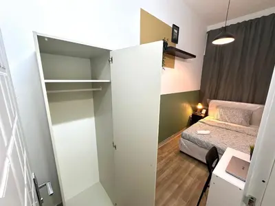a small room with a bed and a closet at Passion Nest Room in Barsha Heights Tecom in Dubai