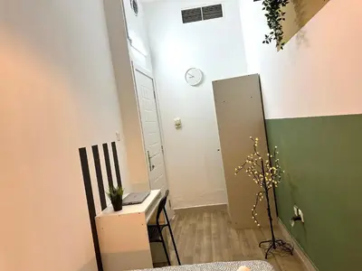 a small room with a white door and a plant at Passion Nest Room in Barsha Heights Tecom in Dubai